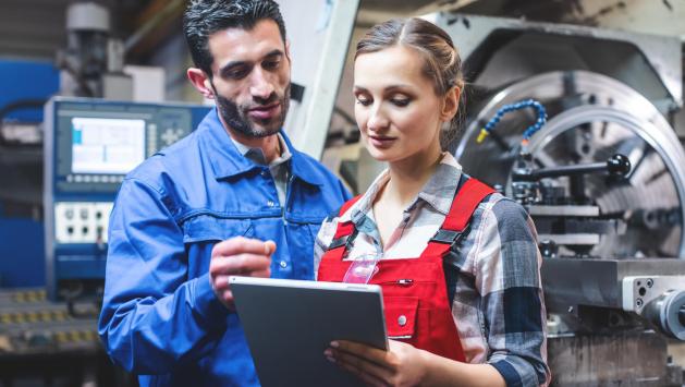 Man and Woman Working in Plant